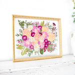 16x20 frame of pressed pink wedding flowers.