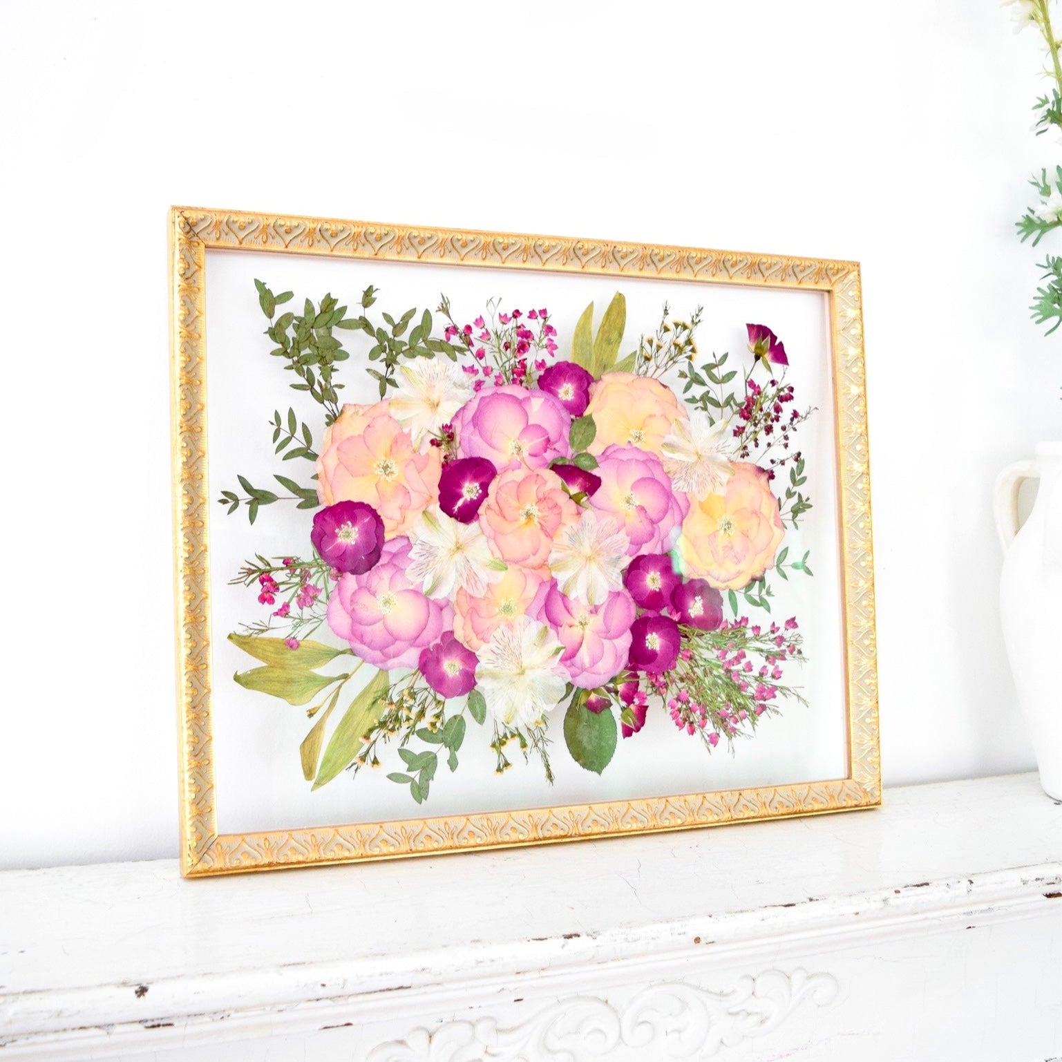 16x20 frame of pressed pink wedding flowers.