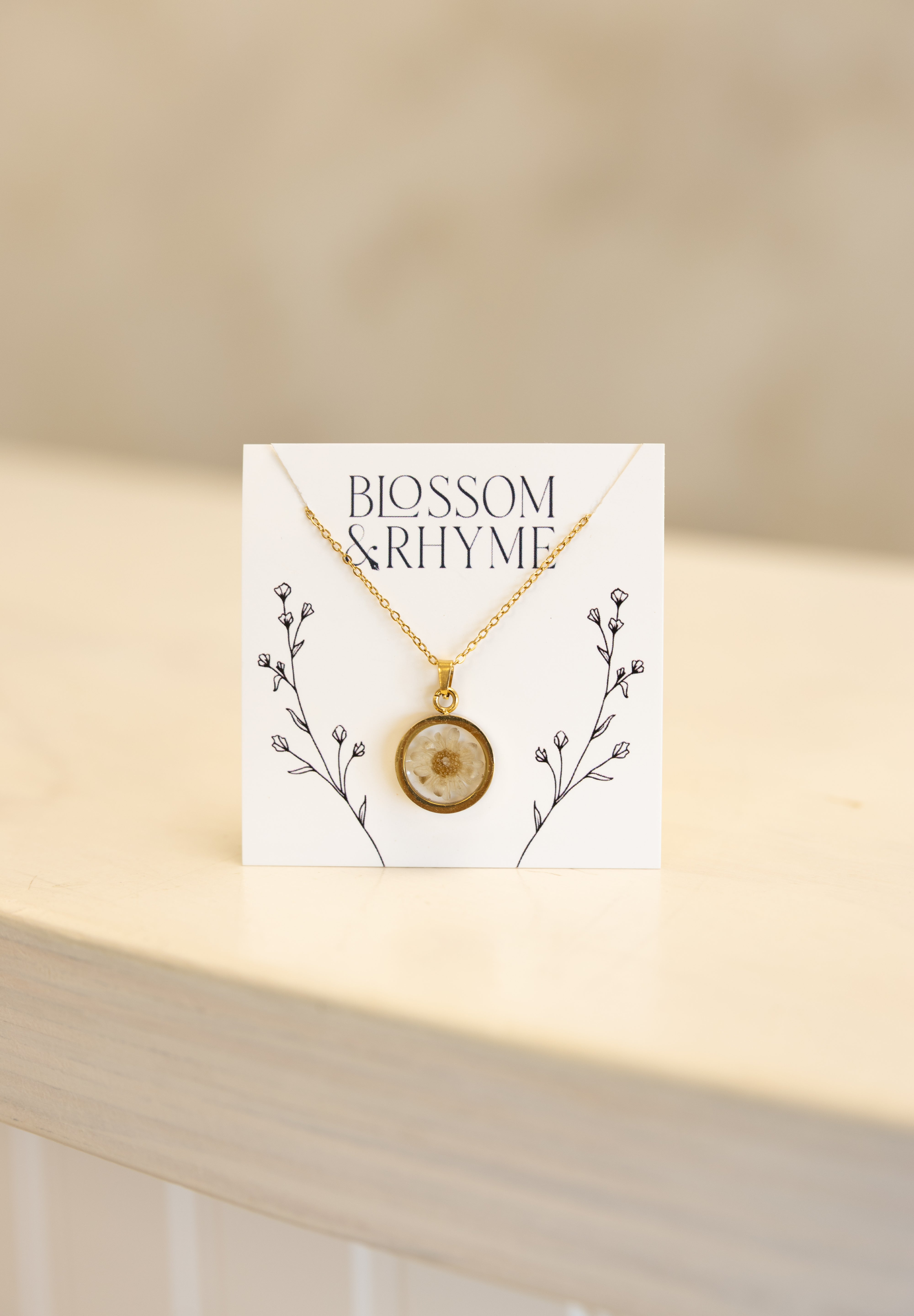 April birth month flower - daisy pressed into a pendant necklace keepsake.