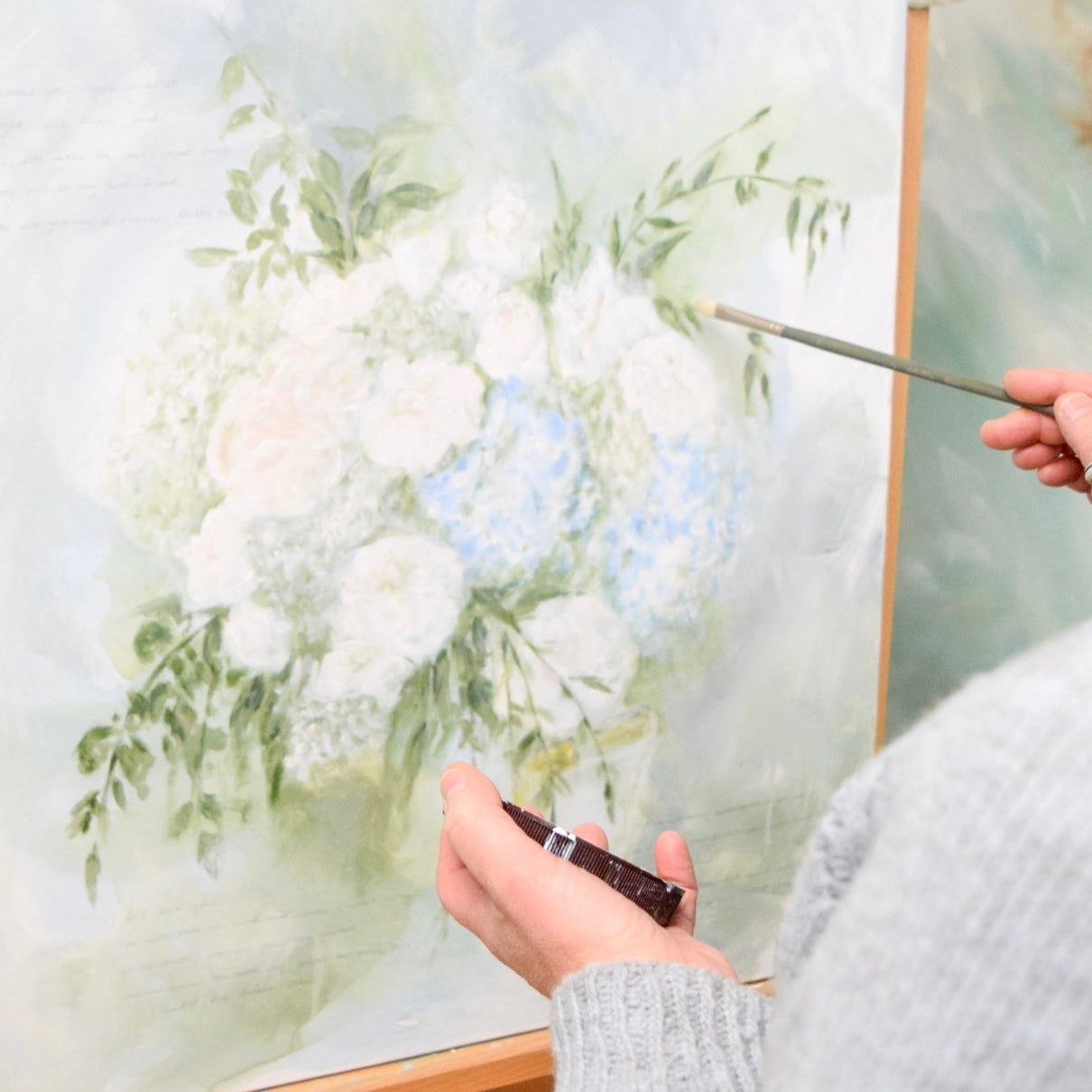 Close-up shot of in-studio painting bridal bouquet for preservation.