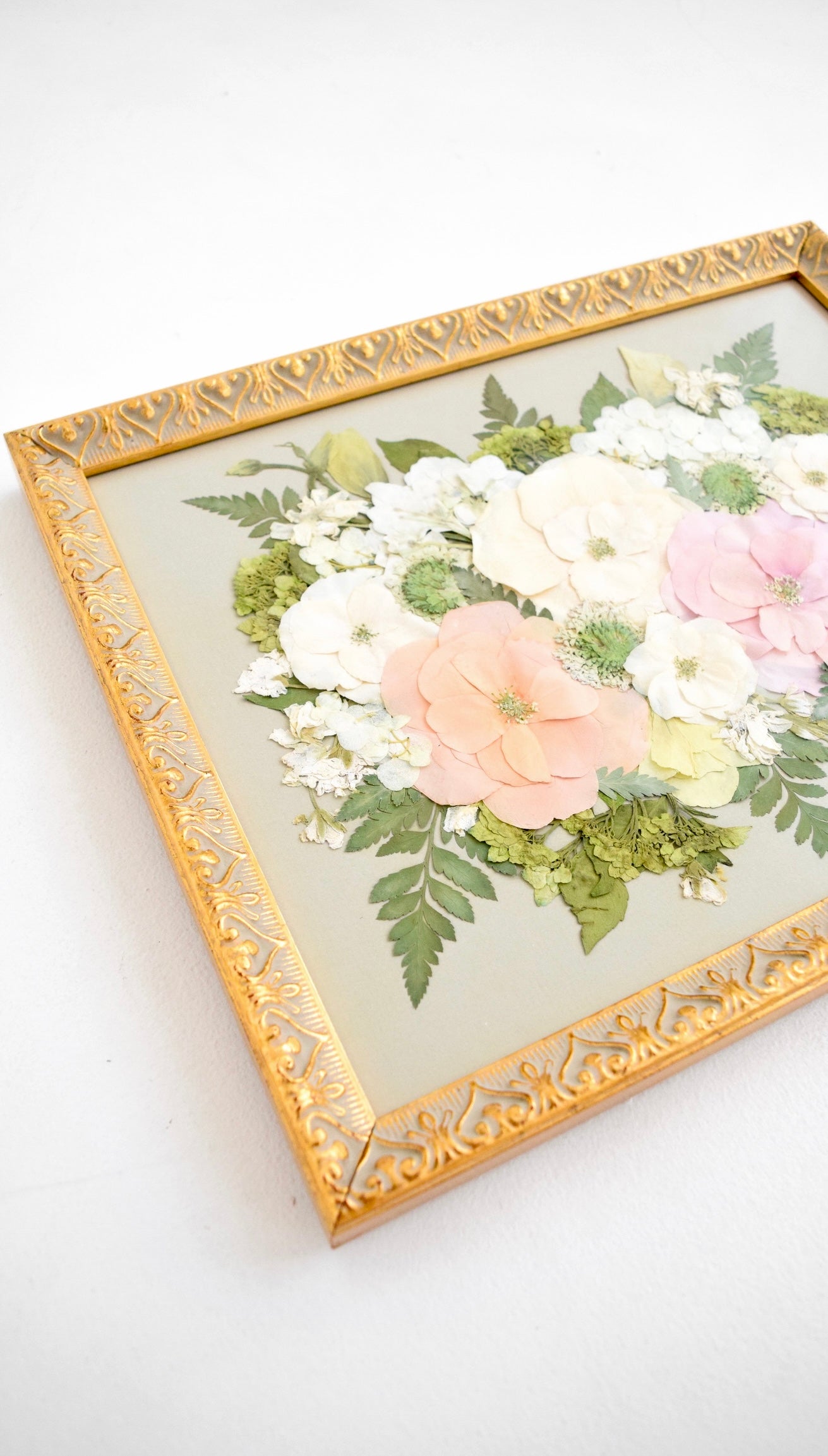 Pressed flower preservation of pastel spring wedding bouquet.