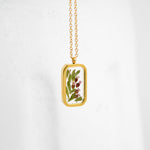 Simple preservation technique for wedding flowers—florals in resin necklace.