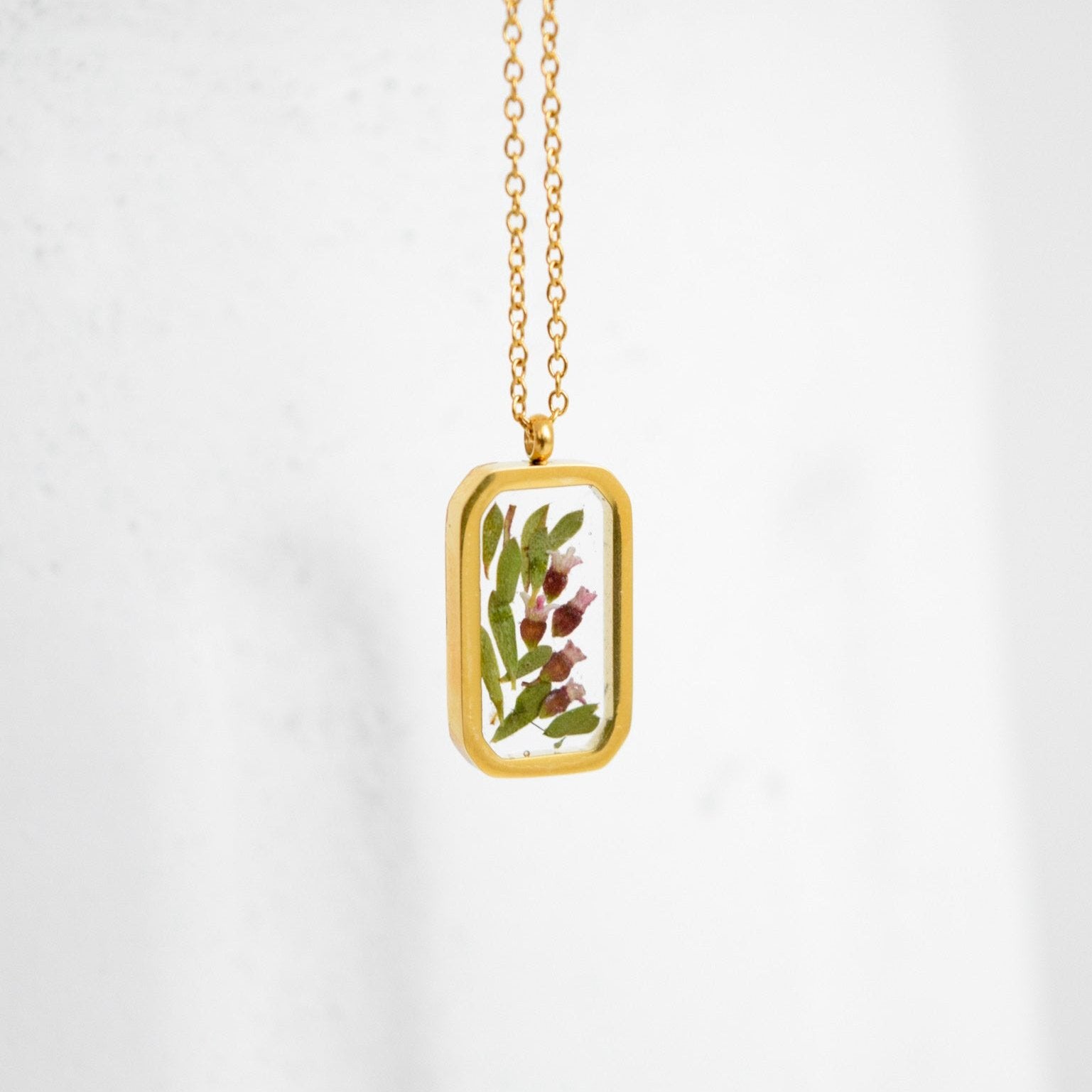Simple preservation technique for wedding flowers—florals in resin necklace.