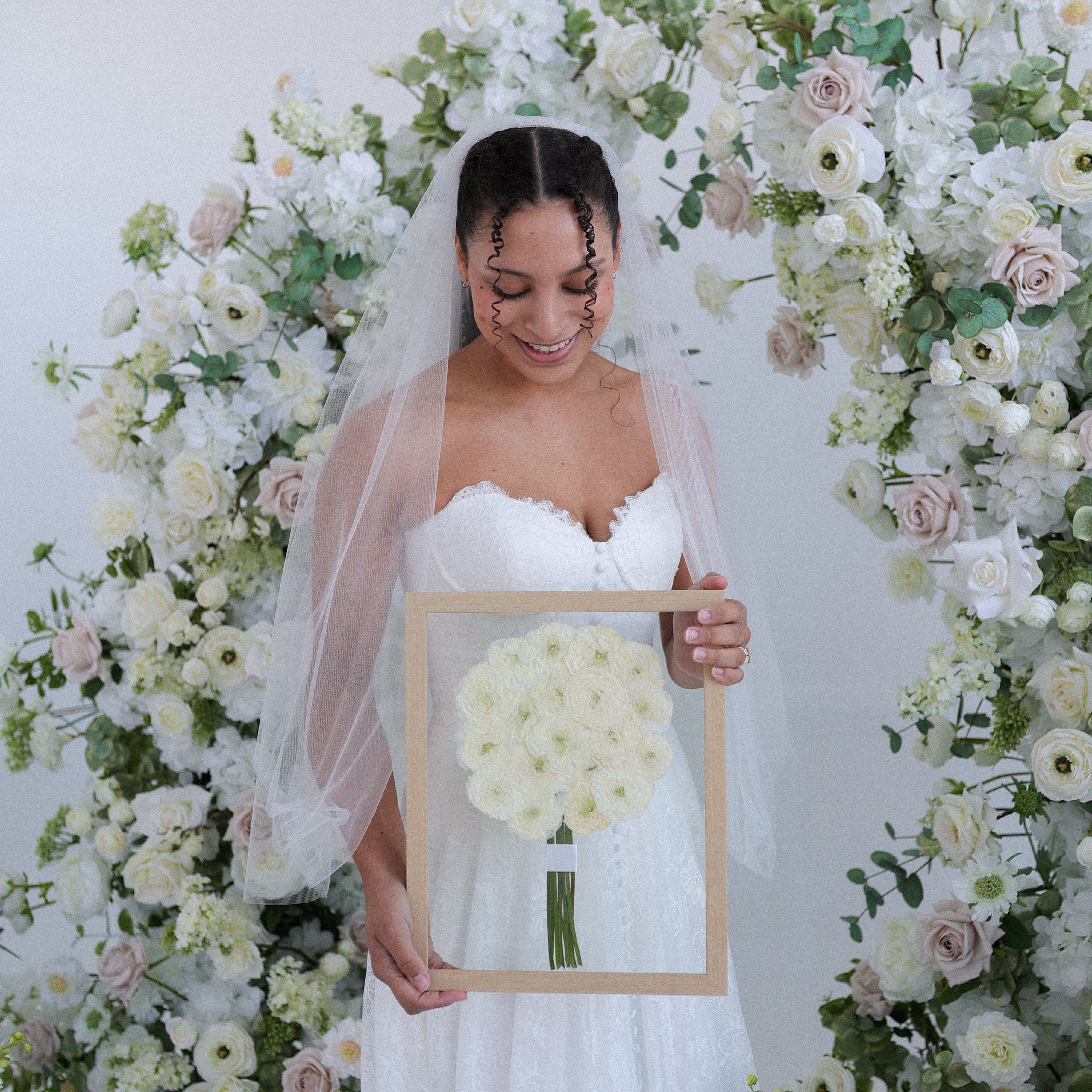 White roses in wedding bouquet pressed for keepsake.