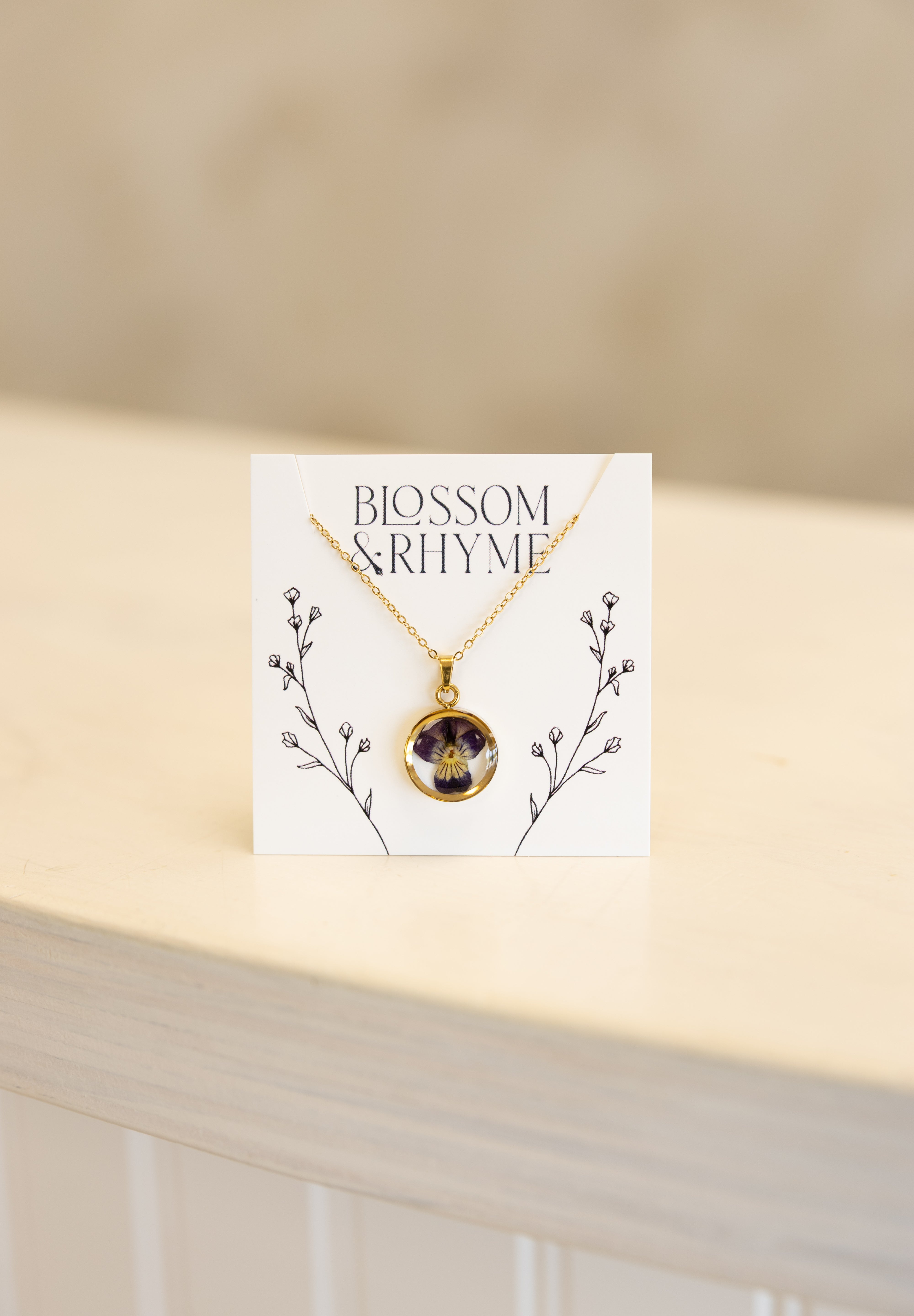 February birth month flower - violet pressed into a pendant necklace keepsake.