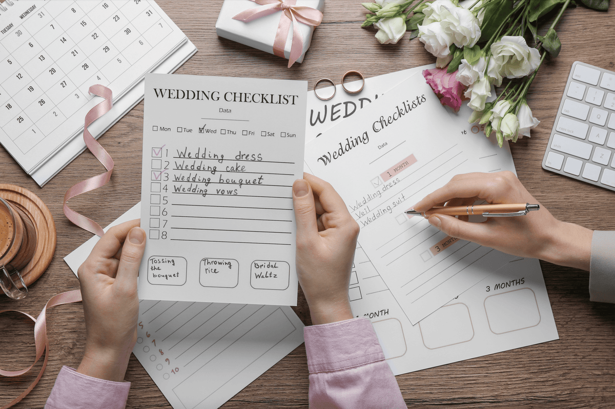 Professional florist arranging roses, peonies, ranunculus, and orchids as the best flowers for wedding bouquet preservation guide.