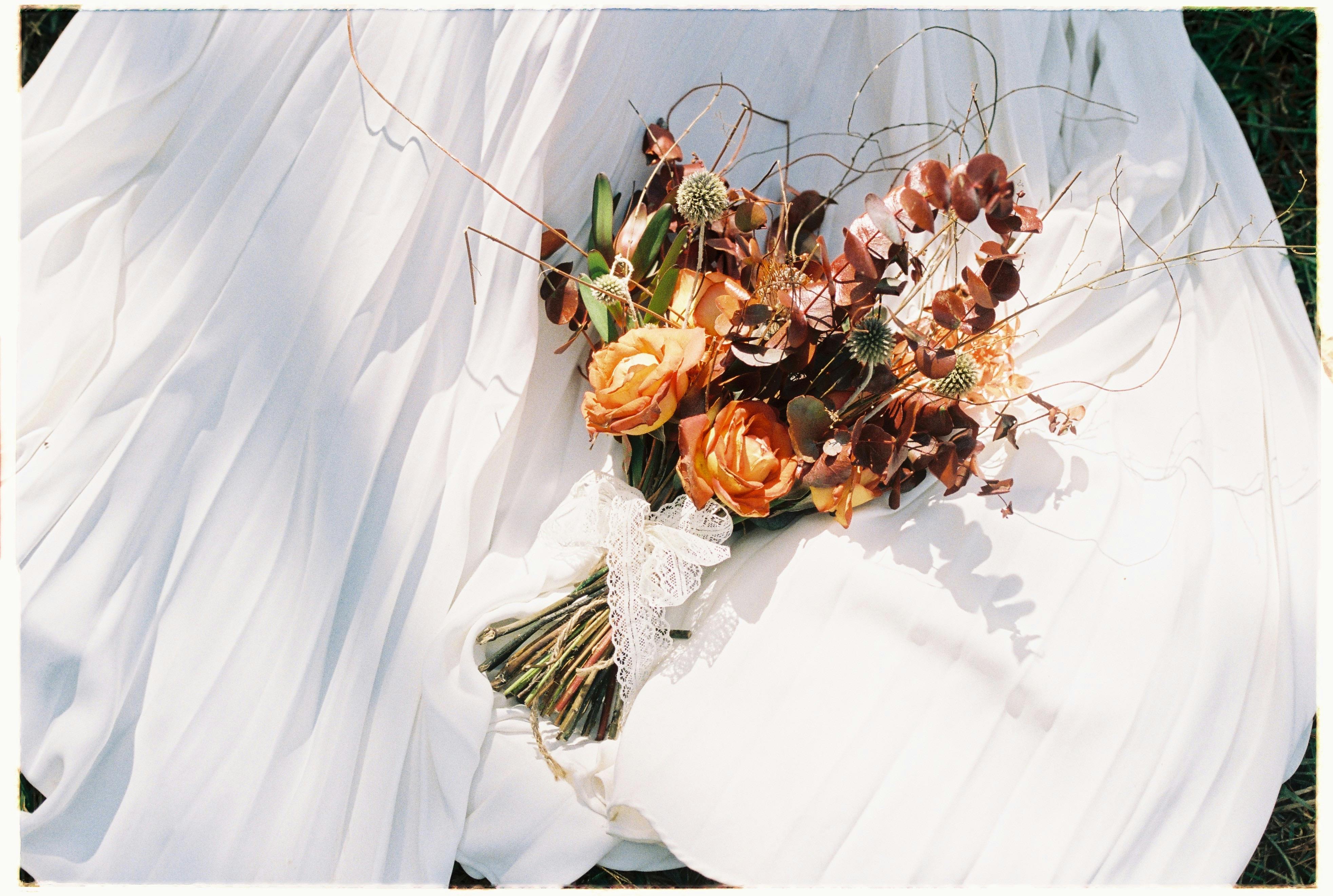 Fall wedding ideas bouquet with seasonal dahlias, roses, dried foliage, and earthy tones preserved as a timeless floral keepsake.