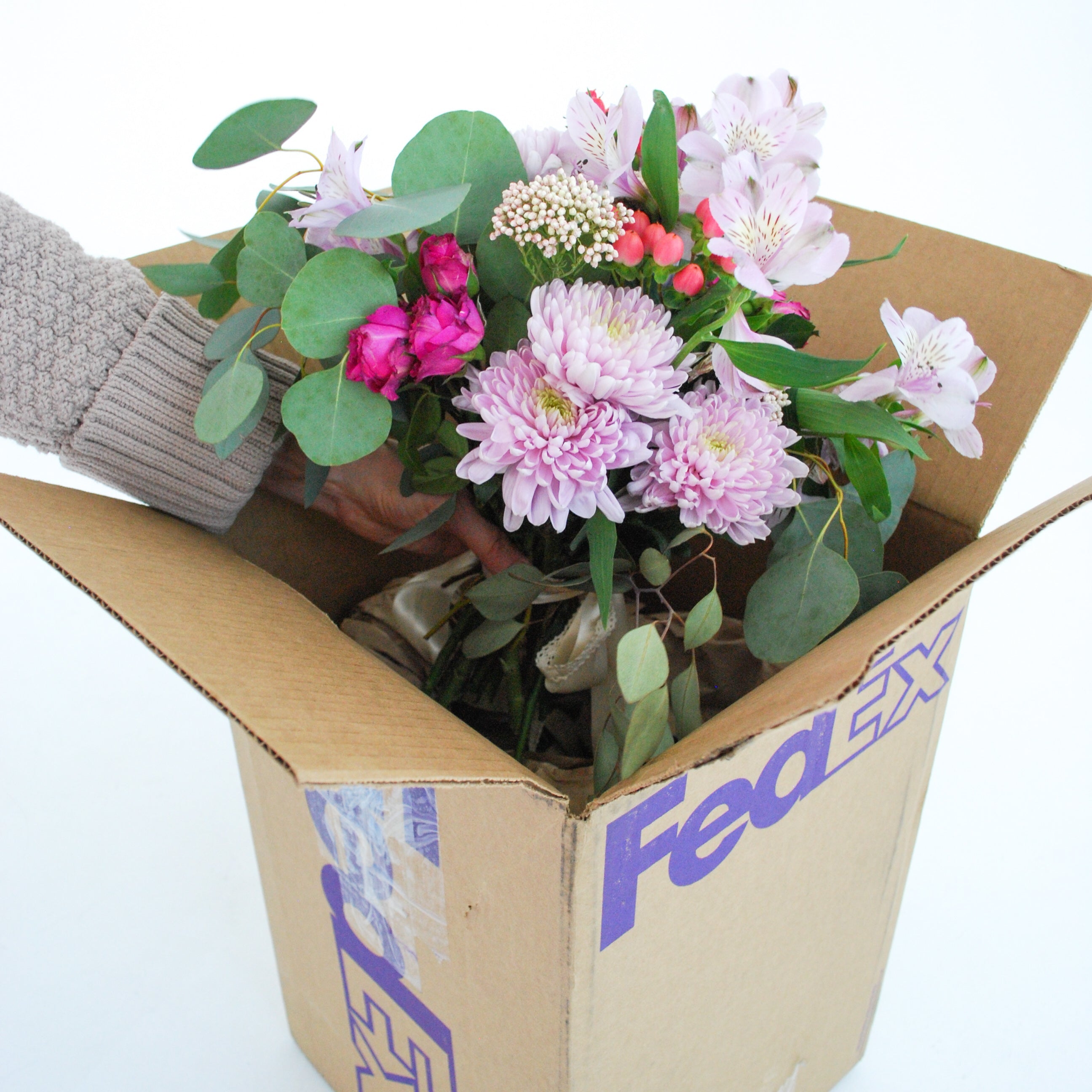 Bride transporting wedding bouquet and floral arrangements in a temperature-controlled vehicle, protecting fresh wedding flowers for ceremony setup and future floral preservation keepsakes.