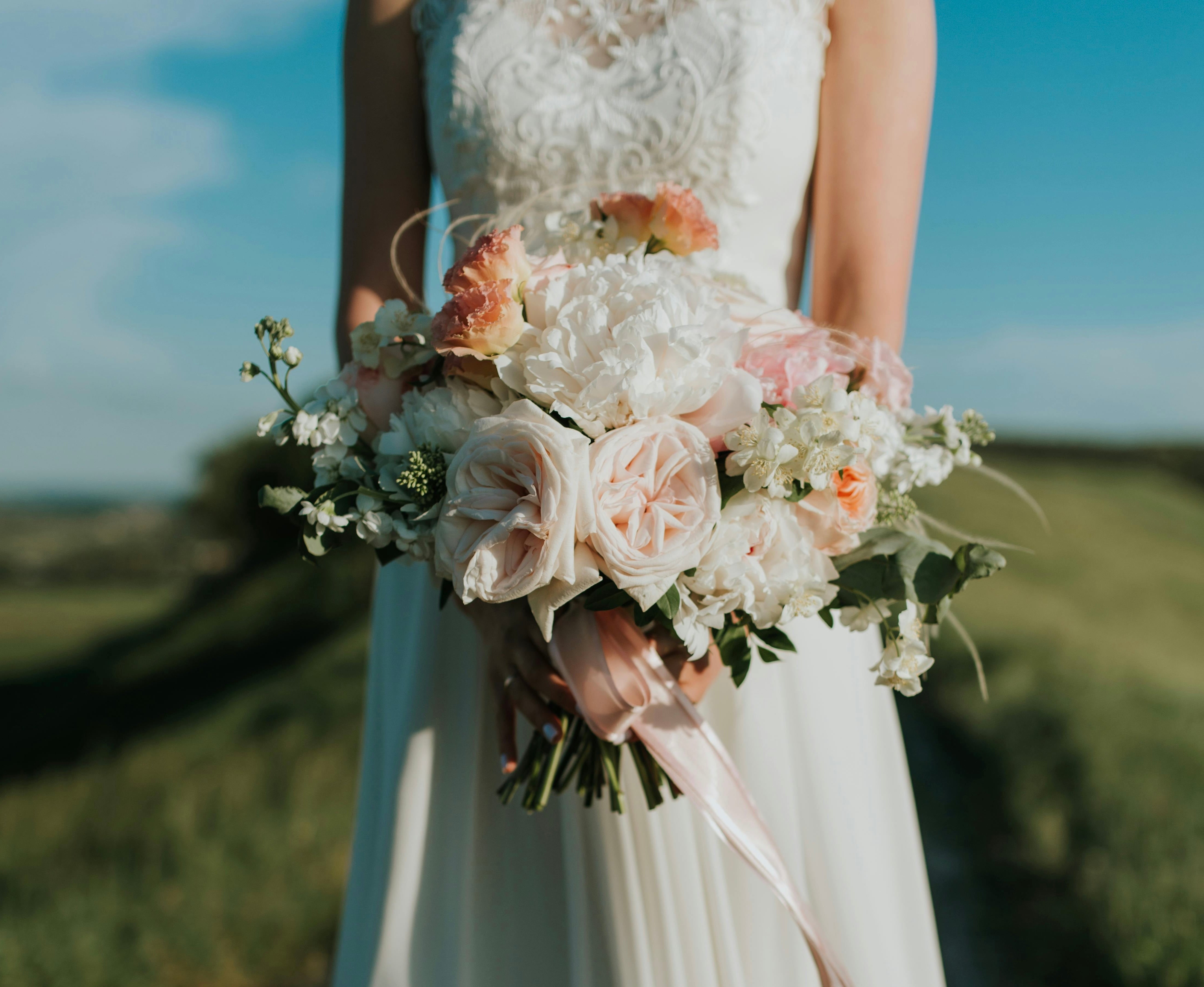 Summer bridal bouquet with seasonal roses, peonies, dahlias, and fresh greenery, beautifully preserved as a timeless wedding flower keepsake.