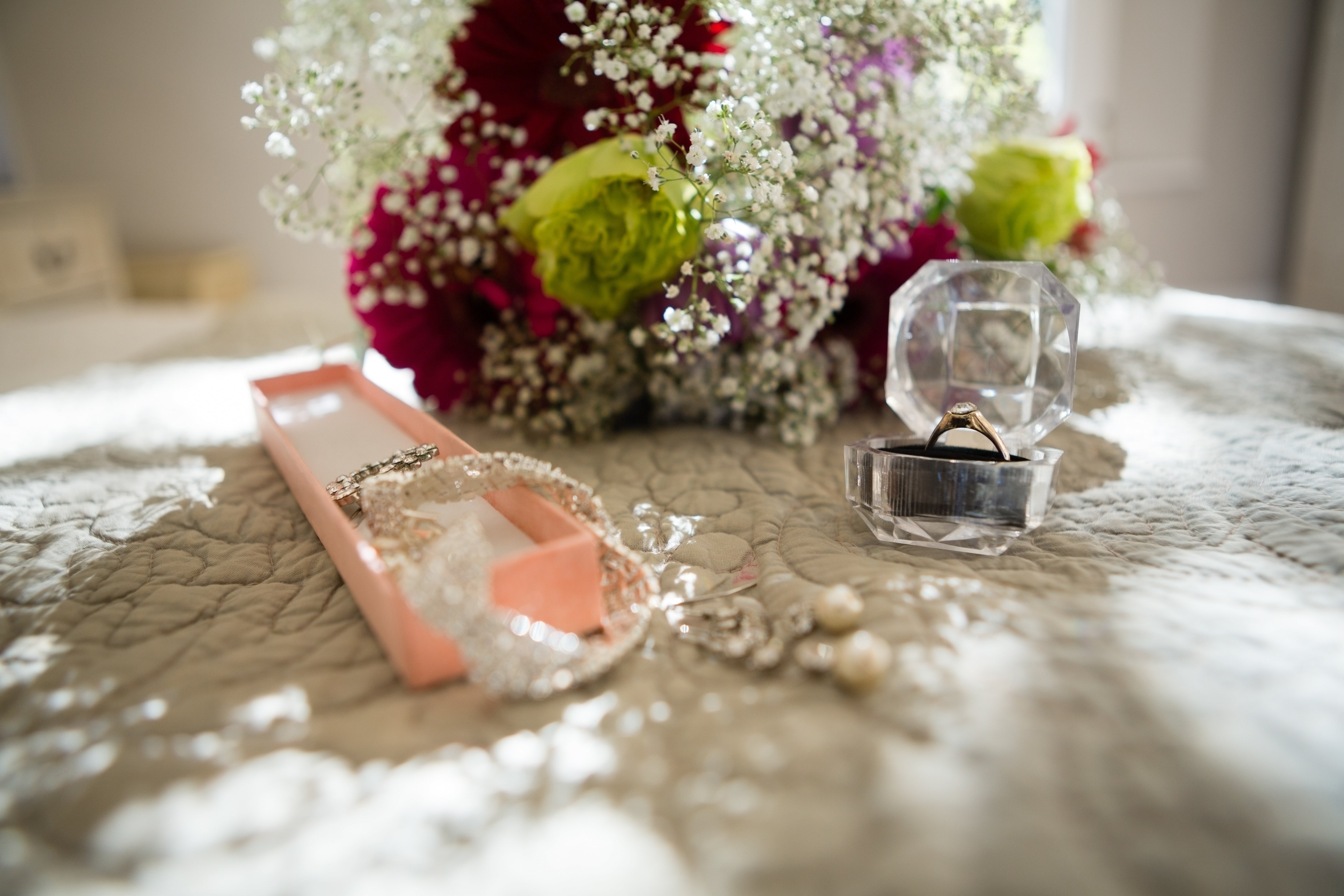 Preserved bridal bouquet displayed with wedding keepsakes and family heirlooms including framed flowers, vows, and resin floral art.