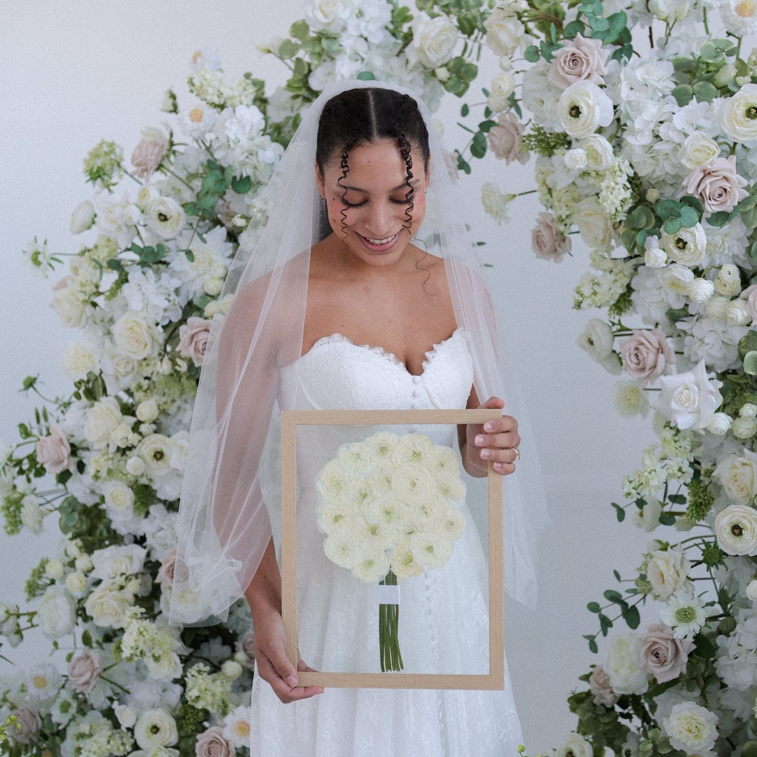 White roses in wedding bouquet pressed for keepsake.