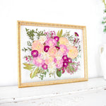 16x20 frame of pressed pink wedding flowers.