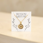 April birth month flower - daisy pressed into a pendant necklace keepsake.