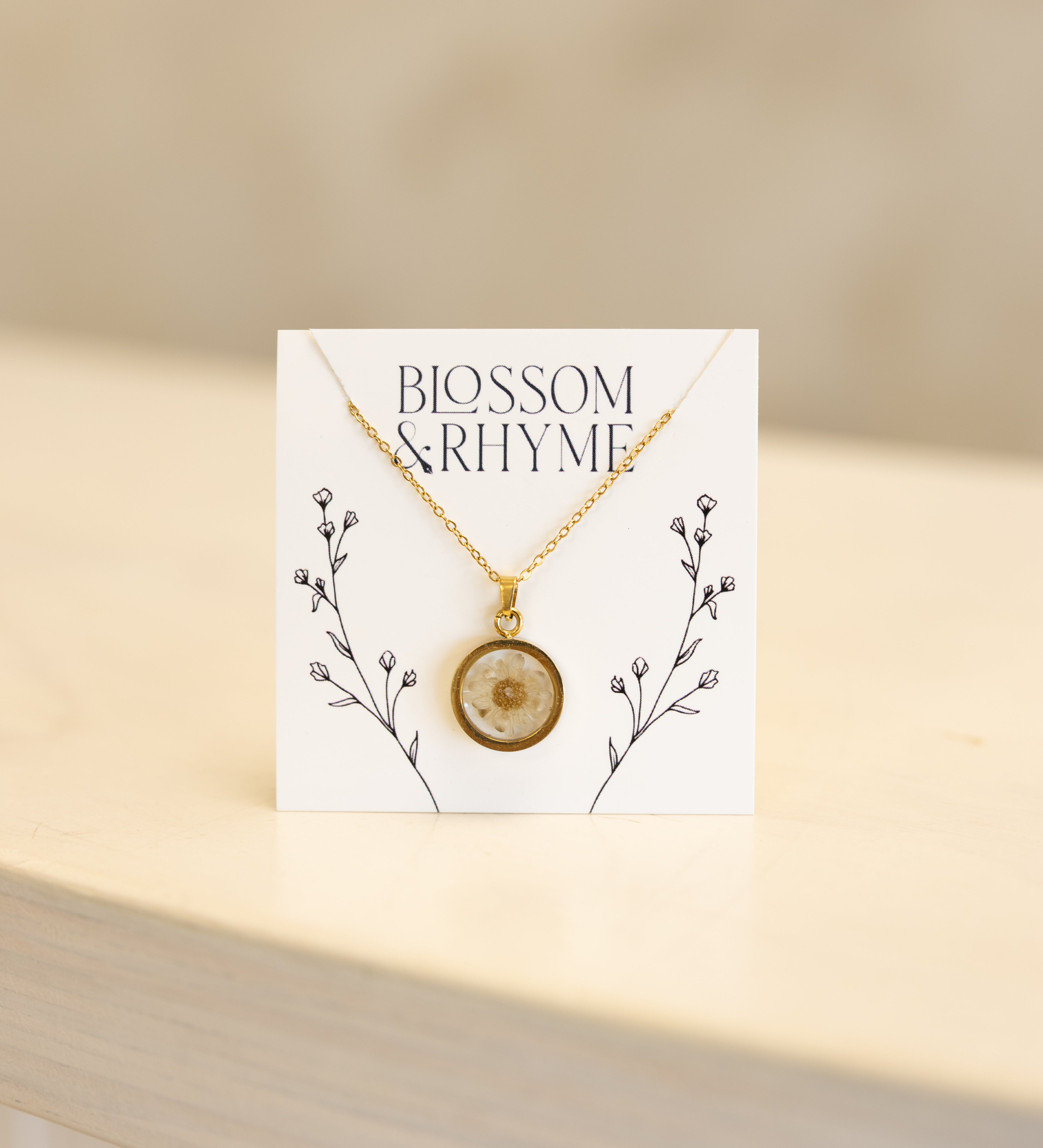 April birth month flower - daisy pressed into a pendant necklace keepsake.