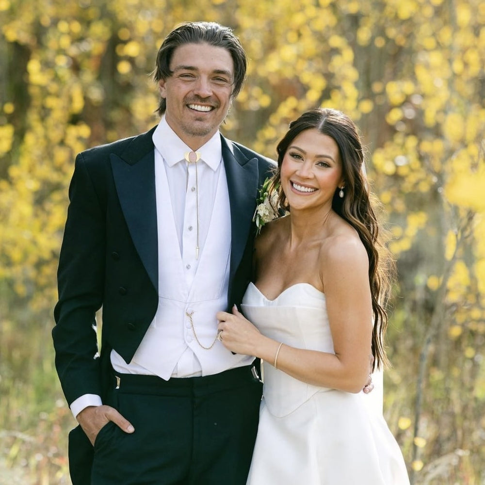 Bride and groom smiling together on their wedding day with preserved bouquet by Blossom & Rhyme