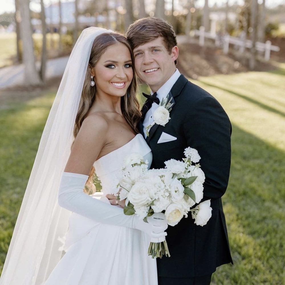 Bride and groom holding a white wedding bouquet before flower preservation by Blossom & Rhyme