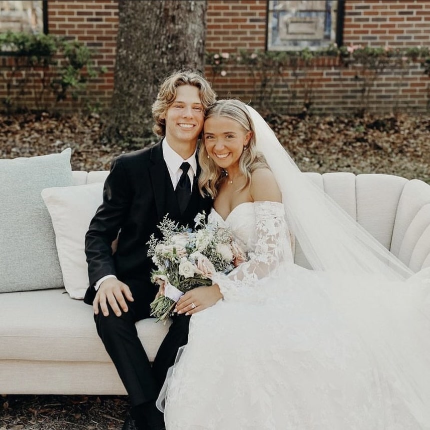 Bride and groom holding a wedding bouquet after their ceremony, preserved by Blossom & Rhyme