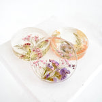Set of round resin floral coasters handcrafted with preserved flowers by Blossom & Rhyme