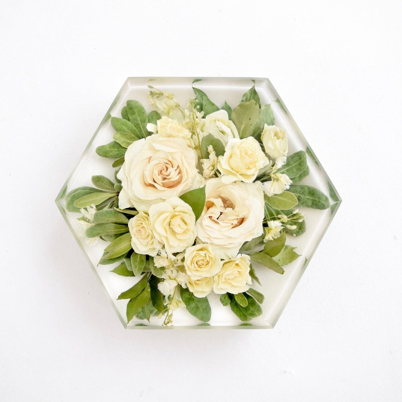 Custom floral keepsake in clear resin block with white roses and greenery.