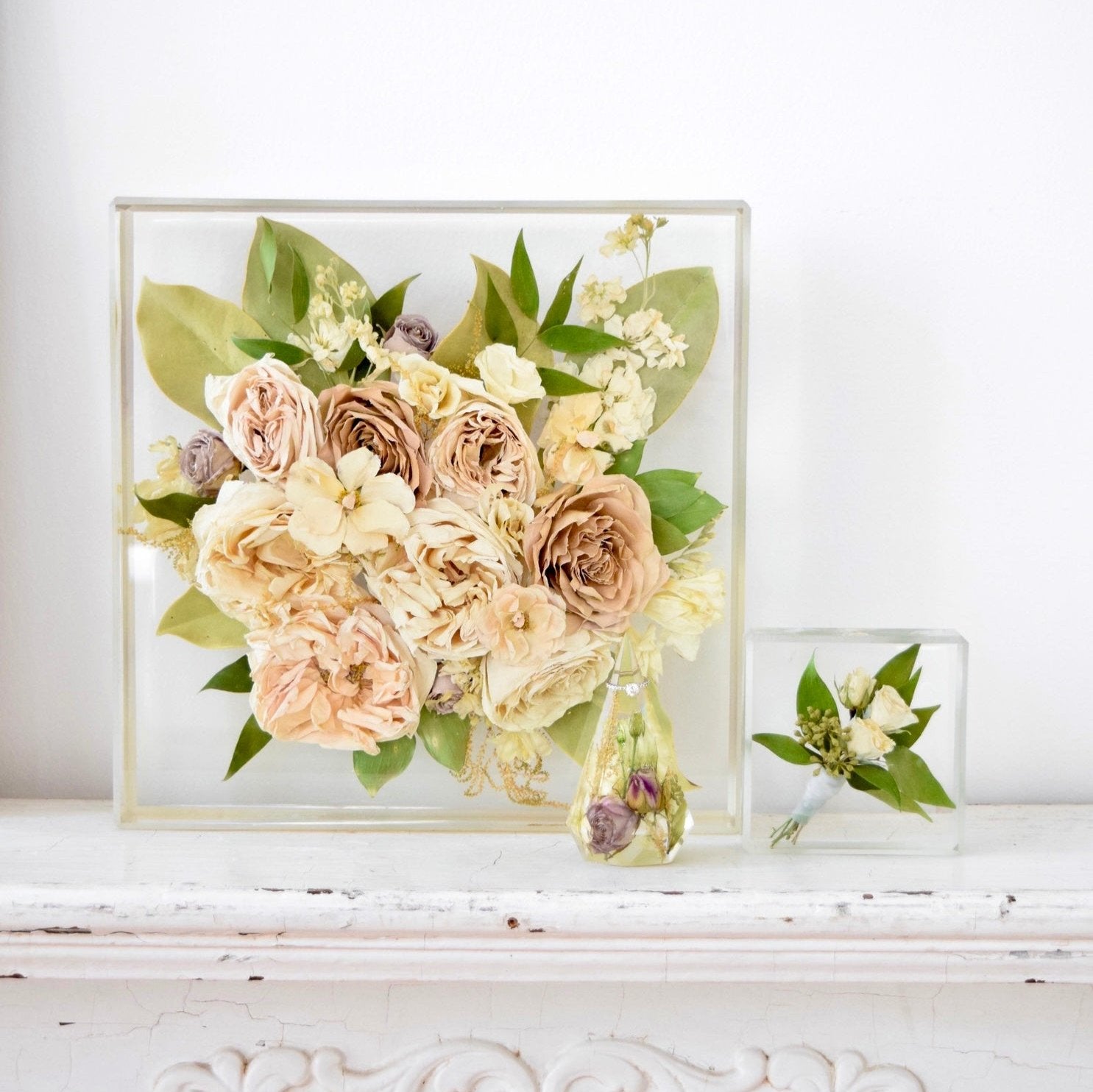 Wedding flower keepsake collection featuring a 12x12 resin floral block, faceted floral keepsake, and mini resin floral block preserving ivory roses, beige garden roses, hydrangeas, stock flowers, eucalyptus, and seasonal greenery, handcrafted by Blossom & Rhyme