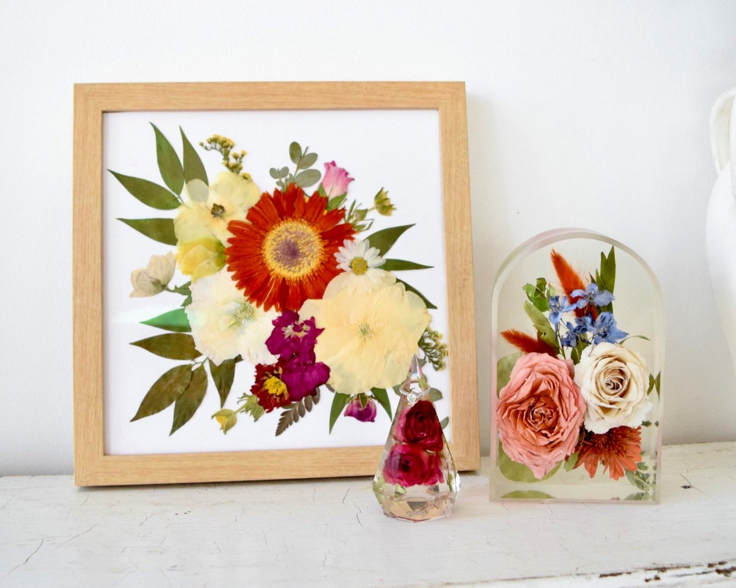 Emily's Herbarium Collection featuring a pressed floral frame, resin floral arch, and botanical keepsake handcrafted from preserved wedding bouquet flowers by Blossom & Rhyme