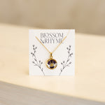 February birth month flower - violet pressed into a pendant necklace keepsake.