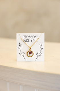 January birth month flower - carnation pressed into a pendant necklace keepsake.