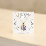 July birth month flower - larkspur pressed into a pendant necklace keepsake.