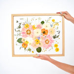 16x20 pressed floral frame featuring preserved pink cosmos, white anemones, orange Iceland poppies, yellow buttercups, blue delphiniums, eucalyptus, and delicate wildflower accents, handcrafted by Blossom & Rhyme