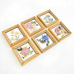 Set of six floral keepsake frames preserving wedding bouquet flowers in a coordinated collage display.