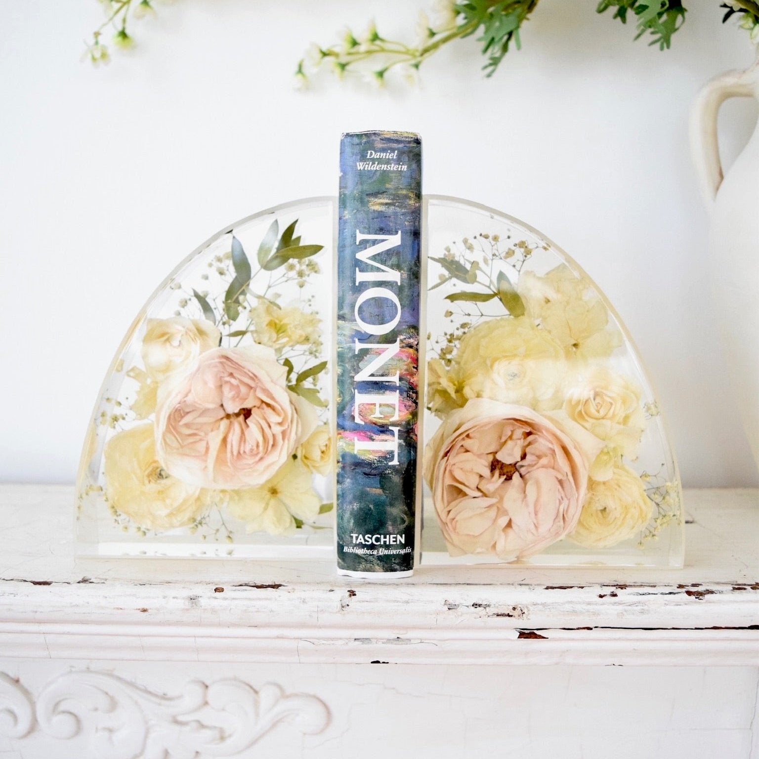 Small resin bookends preserving blush garden roses, ivory roses, white ranunculus, hydrangeas, baby's breath, eucalyptus, and botanical greenery in clear resin, handcrafted by Blossom & Rhyme