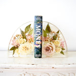 Small resin bookends preserving ivory roses, blush roses, spray roses, wax flowers, eucalyptus, and delicate greenery in clear resin, handcrafted by Blossom & Rhyme