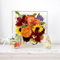 Resin floral keepsake collection featuring a large resin floral block, custom floral ornament, and faceted floral keepsake preserving orange garden roses, burgundy orchids, yellow sunflowers, purple hydrangeas, ranunculus, fern fronds, and botanical greenery, handcrafted by Blossom & Rhyme