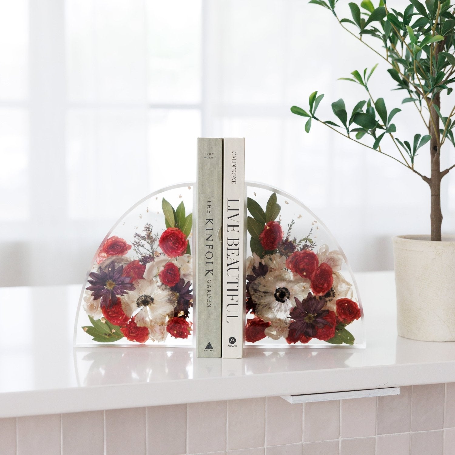Large custom resin bookends handcrafted with preserved flowers for elegant home décor and book displays.