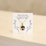 February birth month flower - violet pressed into a pendant necklace keepsake.