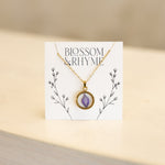July birth month flower - larkspur pressed into a pendant necklace keepsake.