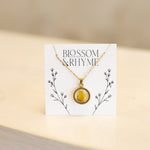 October birth month flower - marigold pressed into a pendant necklace keepsake.