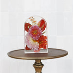 Small resin arch featuring preserved wedding flowers in a handcrafted display. 